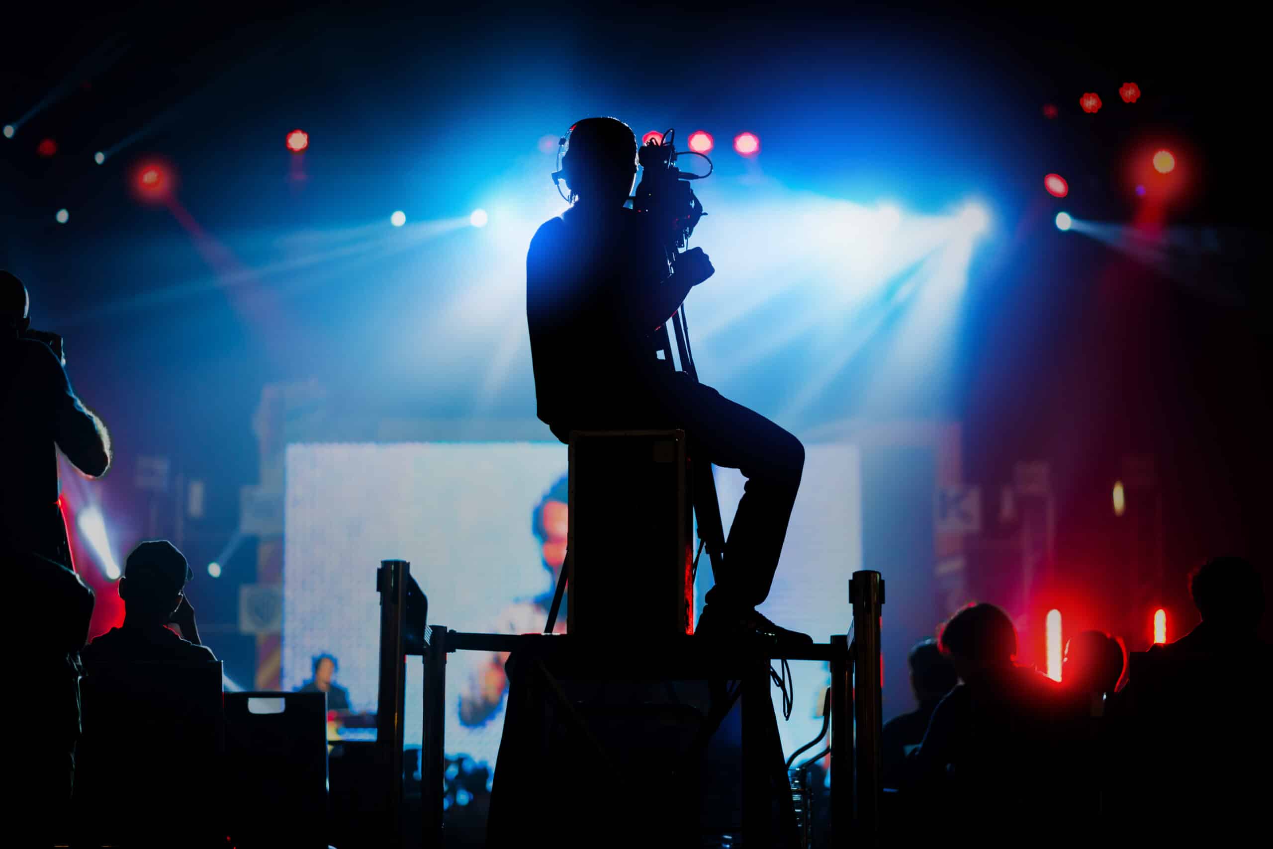professional cameraman record live concert with beam spot and light performance